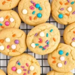 Soft and chewy White Chocolate Confetti Cookies with rainbow sprinkles on a cooling rack